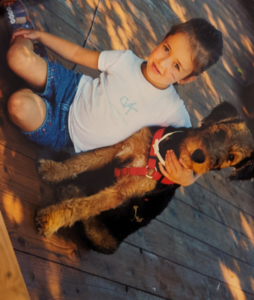 Holding a photo of myself at age 6, hugging my Airedale Terrier puppy.